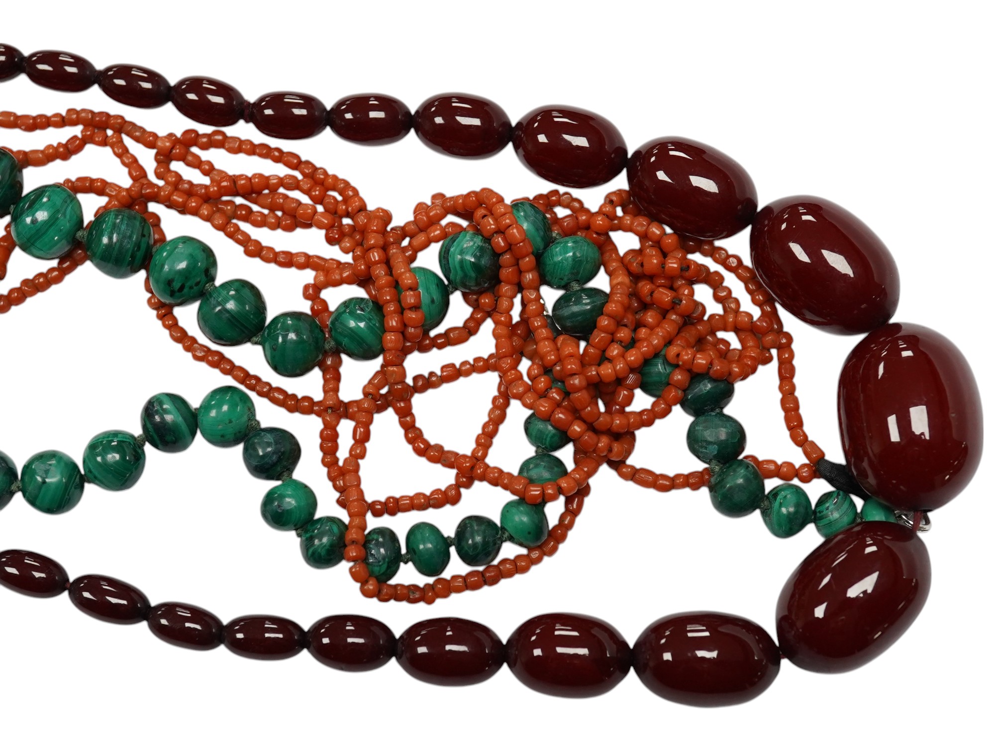 A graduated simulated cherry amber bead necklace, 43cm, gross weight 54 grams and two other necklaces including malachite. Condition - fair to good